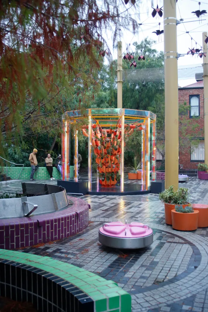 BioRhythm seen across the curved green-tiled seating of Grattan Gardens