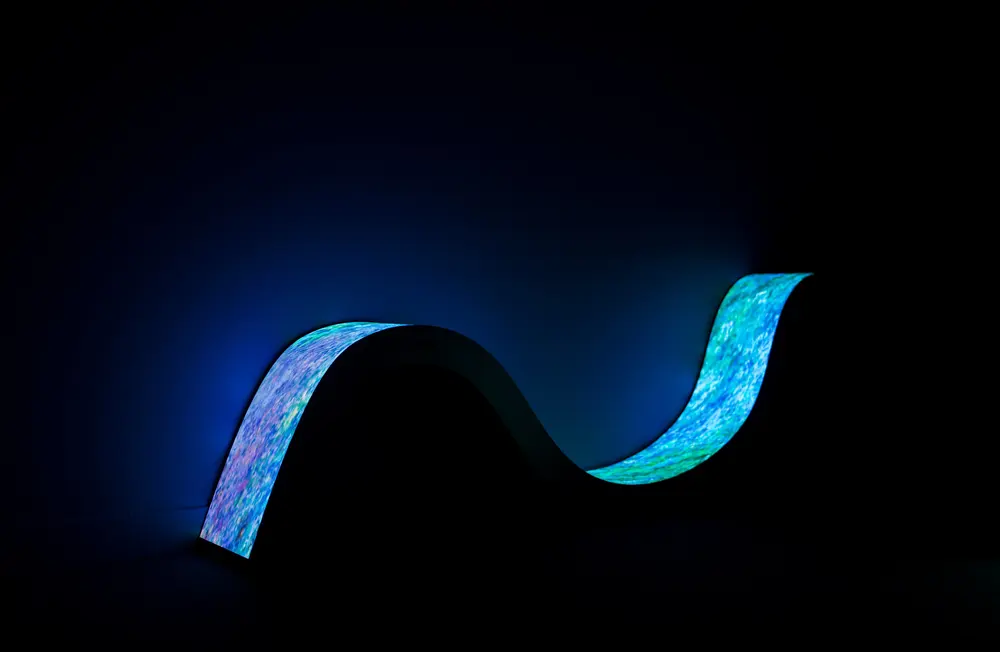 Blue and teal LED wave floating in the dark
